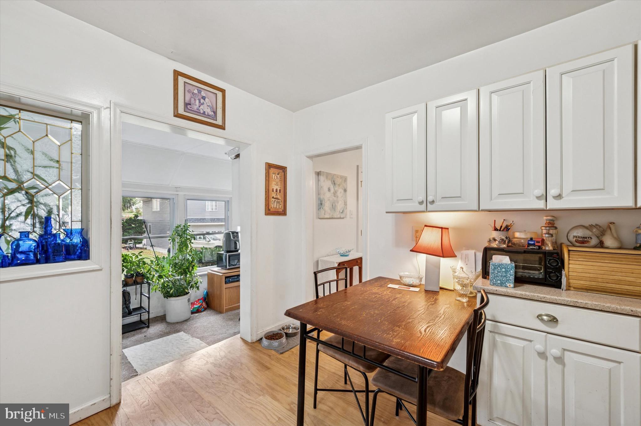 15 Oakland Road Broomall, PA 19008 - Photo 14 of 27 a kitchen with stainless steel appliances dining table chairs and cabinets