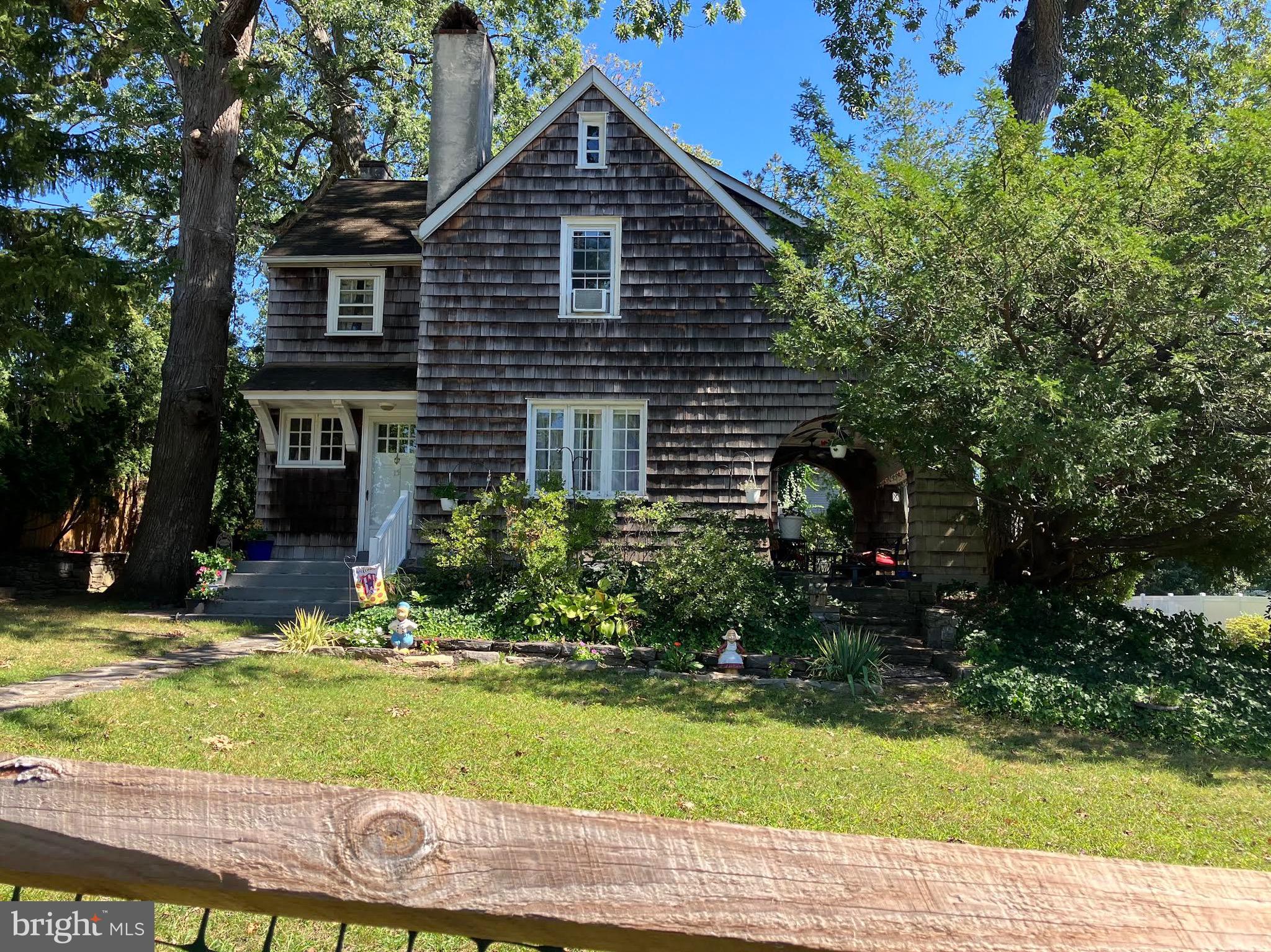 15 Oakland Road Broomall, PA 19008 - Photo 2 of 27 a brick house with a yard potted plants and large trees