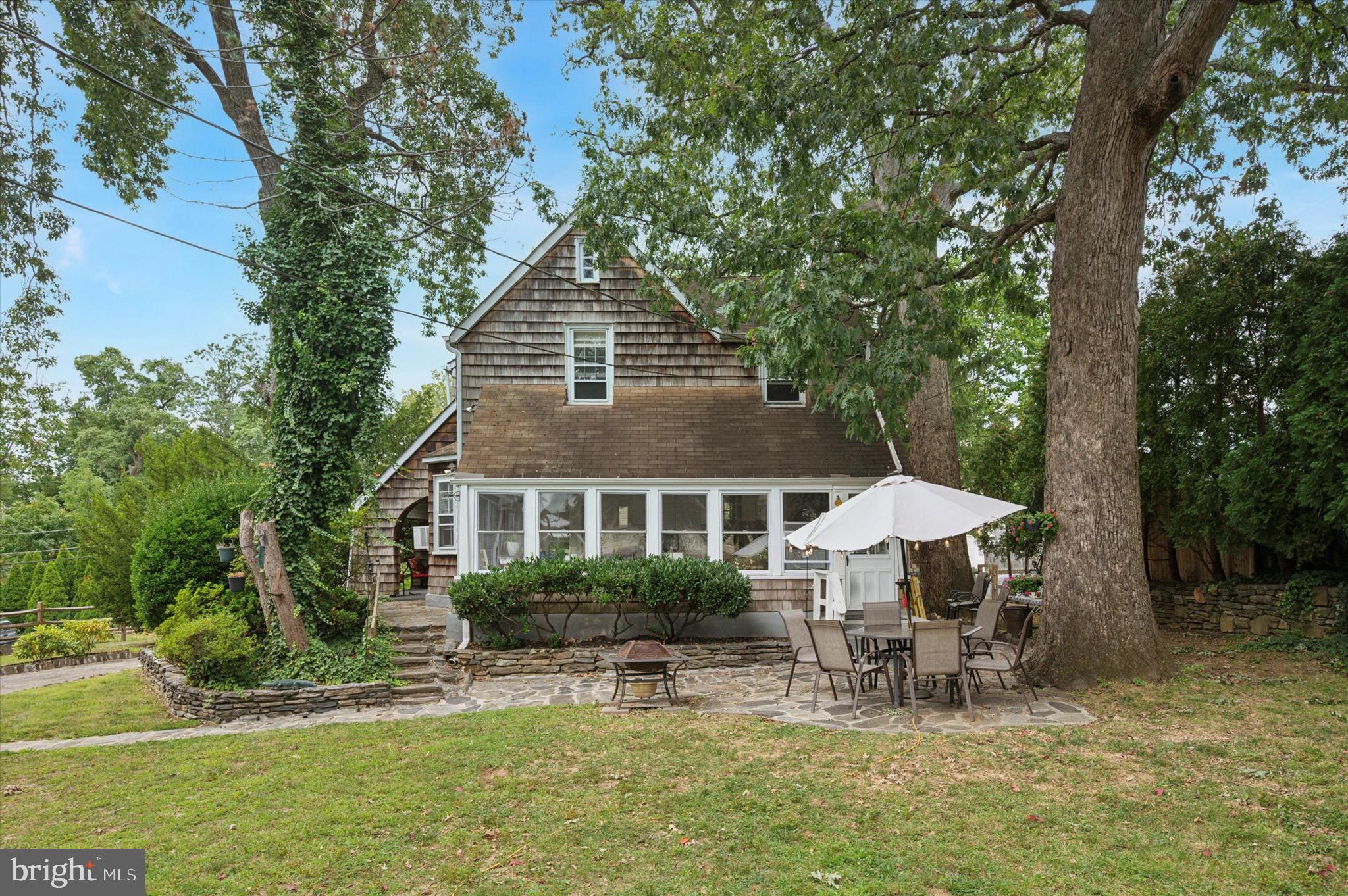 15 Oakland Road Broomall, PA 19008 - Photo 24 of 27 a backyard of a house with table and chairs with wooden fence and plants