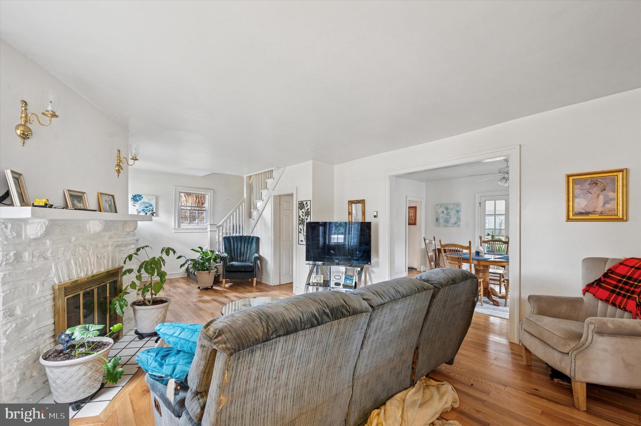 15 Oakland Road Broomall, PA 19008 - Photo 9 of 27 a living room with furniture a fireplace and a flat screen tv