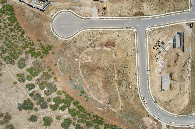 1817 North Dean Court, Unit 12 Alpine, UT 84004 - Photo 11 of 38 Aerial perspective of a developing residential area featuring paved streets, a cul-de-sac, and undeveloped land with natural vegetation