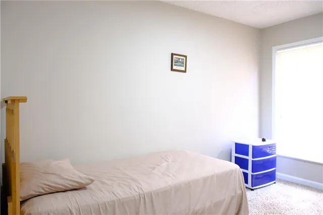 a bedroom with a bed and a cabinet