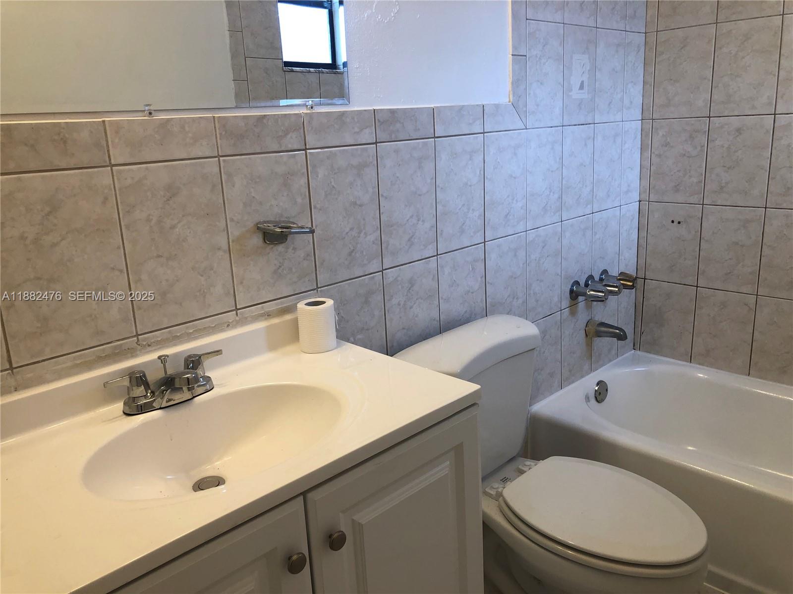 10250 Southwest 172nd Street Miami, FL 33157 - Photo 11 of 39 a bathroom with a sink a toilet and bathtub