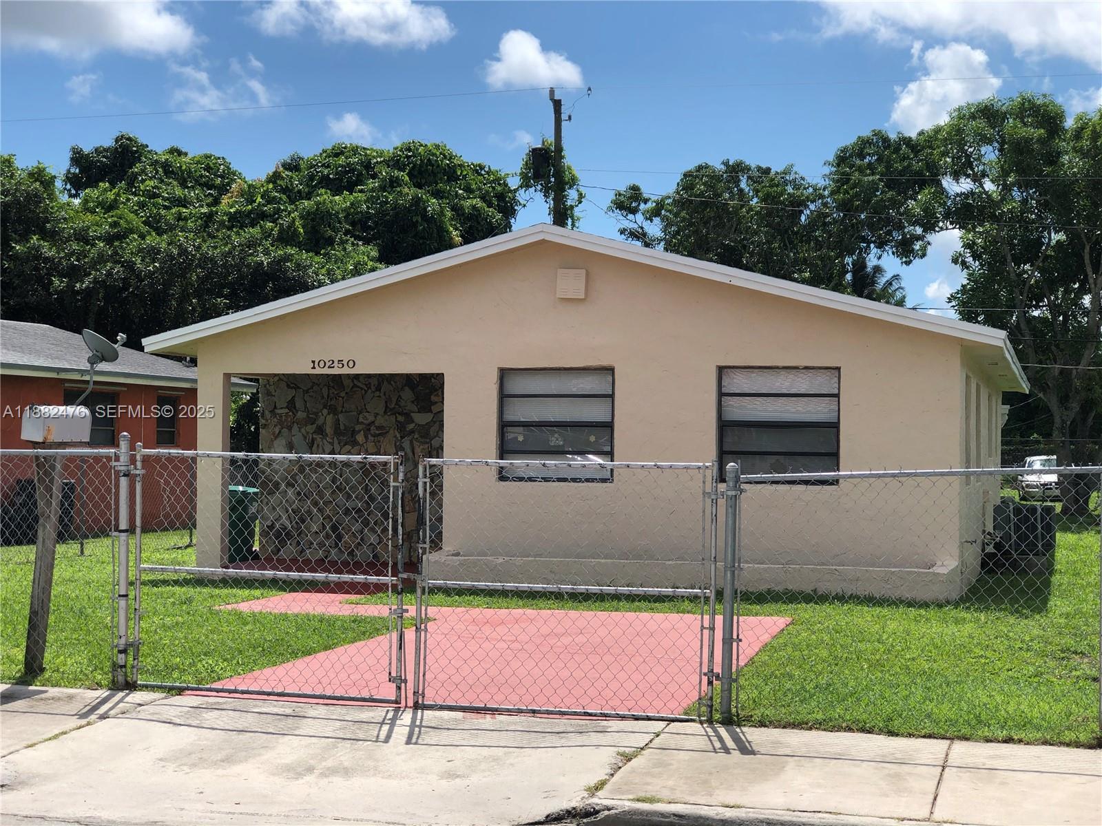 10250 Southwest 172nd Street Miami, FL 33157 - Photo 12 of 39 a front view of a house with a garden