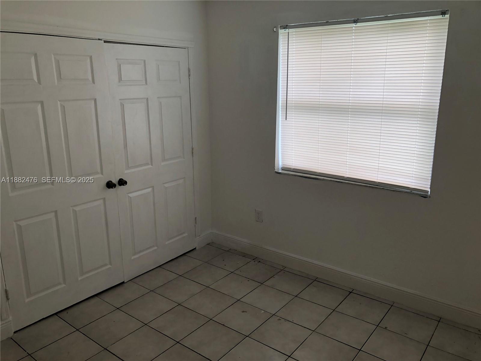 10250 Southwest 172nd Street Miami, FL 33157 - Photo 16 of 39 an empty room with wooden floor and cabinet