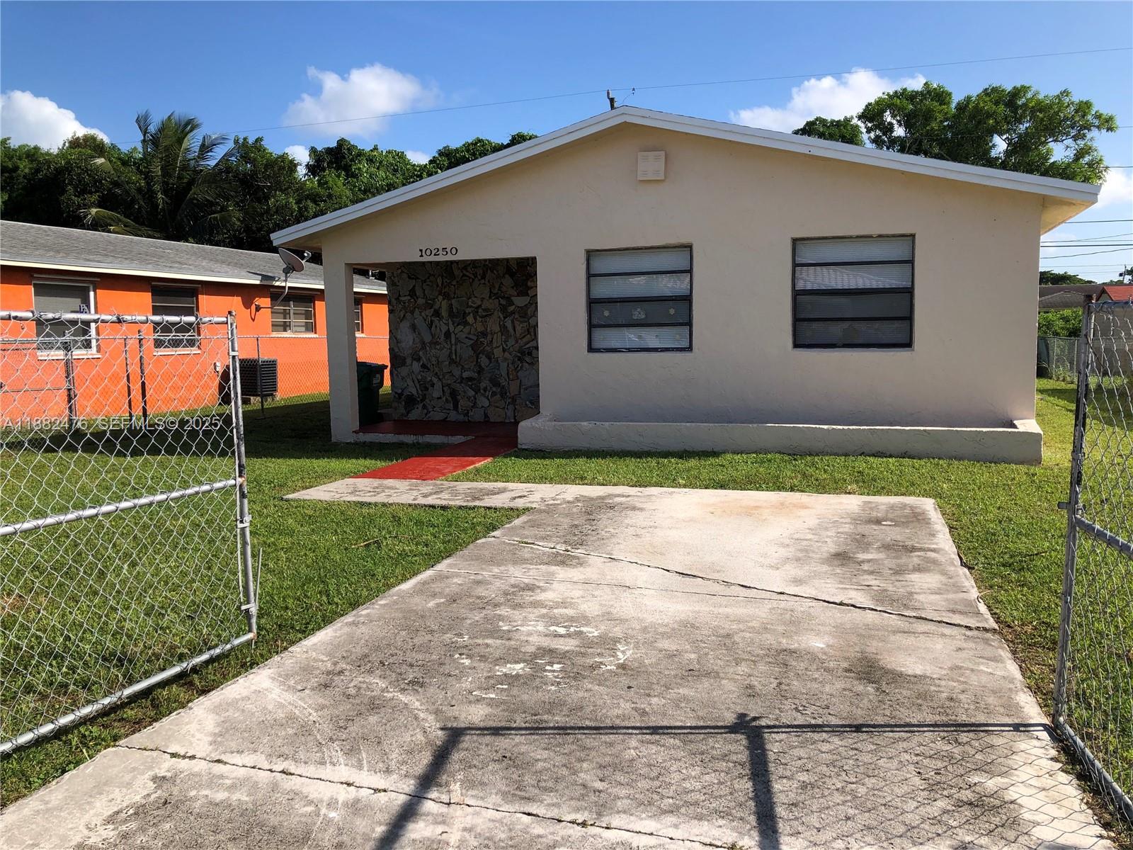 10250 Southwest 172nd Street Miami, FL 33157 - Photo 24 of 39 a front view of a house with a yard