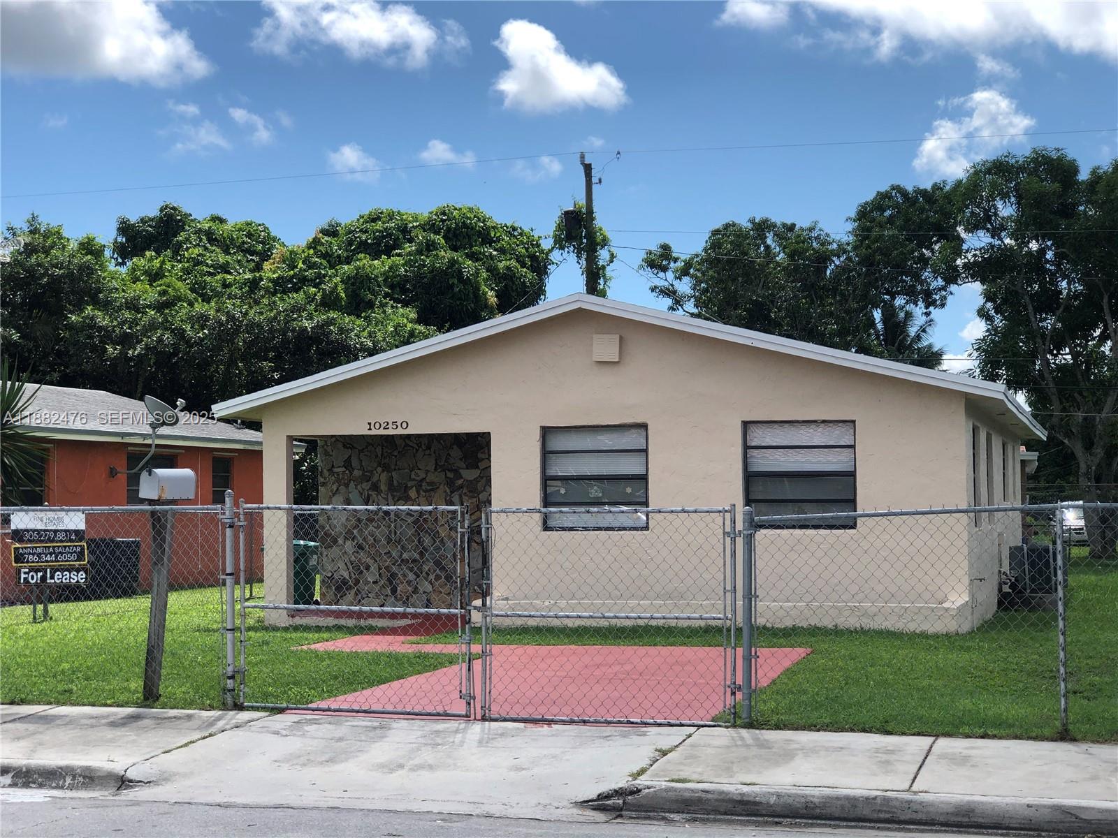 10250 Southwest 172nd Street Miami, FL 33157 - Photo 25 of 39 a view of a white house with a yard and plants