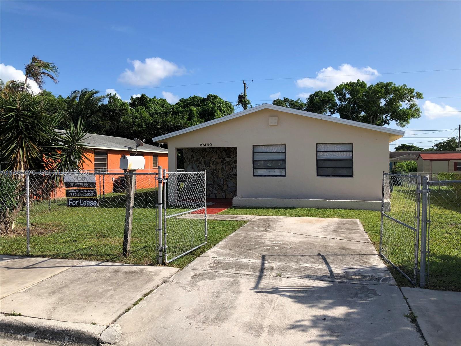 10250 Southwest 172nd Street Miami, FL 33157 - Photo 34 of 39 a front view of a house with a yard and garage