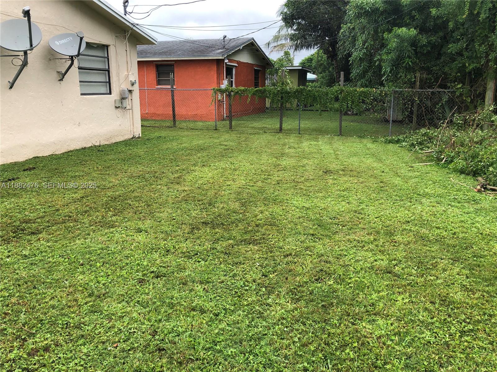 10250 Southwest 172nd Street Miami, FL 33157 - Photo 36 of 39 a backyard of a house with lots of green space