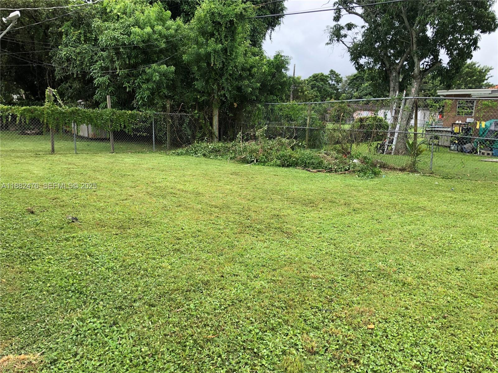 10250 Southwest 172nd Street Miami, FL 33157 - Photo 6 of 39 a backyard of a house with lots of green space
