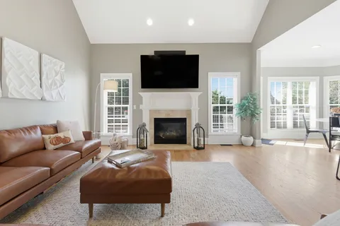 a kitchen with stainless steel appliances kitchen island granite countertop a refrigerator and a sink