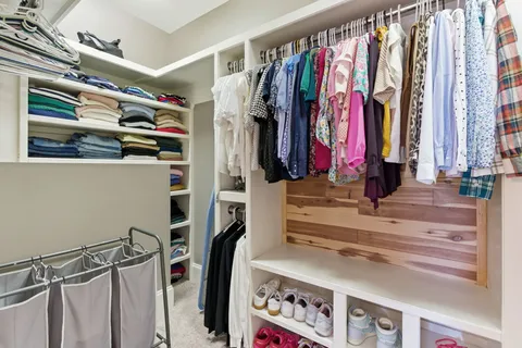 a bedroom with a large bed and a mirror