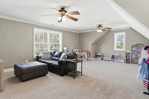 a view of a patio with table and chairs stove and floor to ceiling window