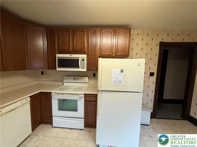 a kitchen with stainless steel appliances a refrigerator stove and sink