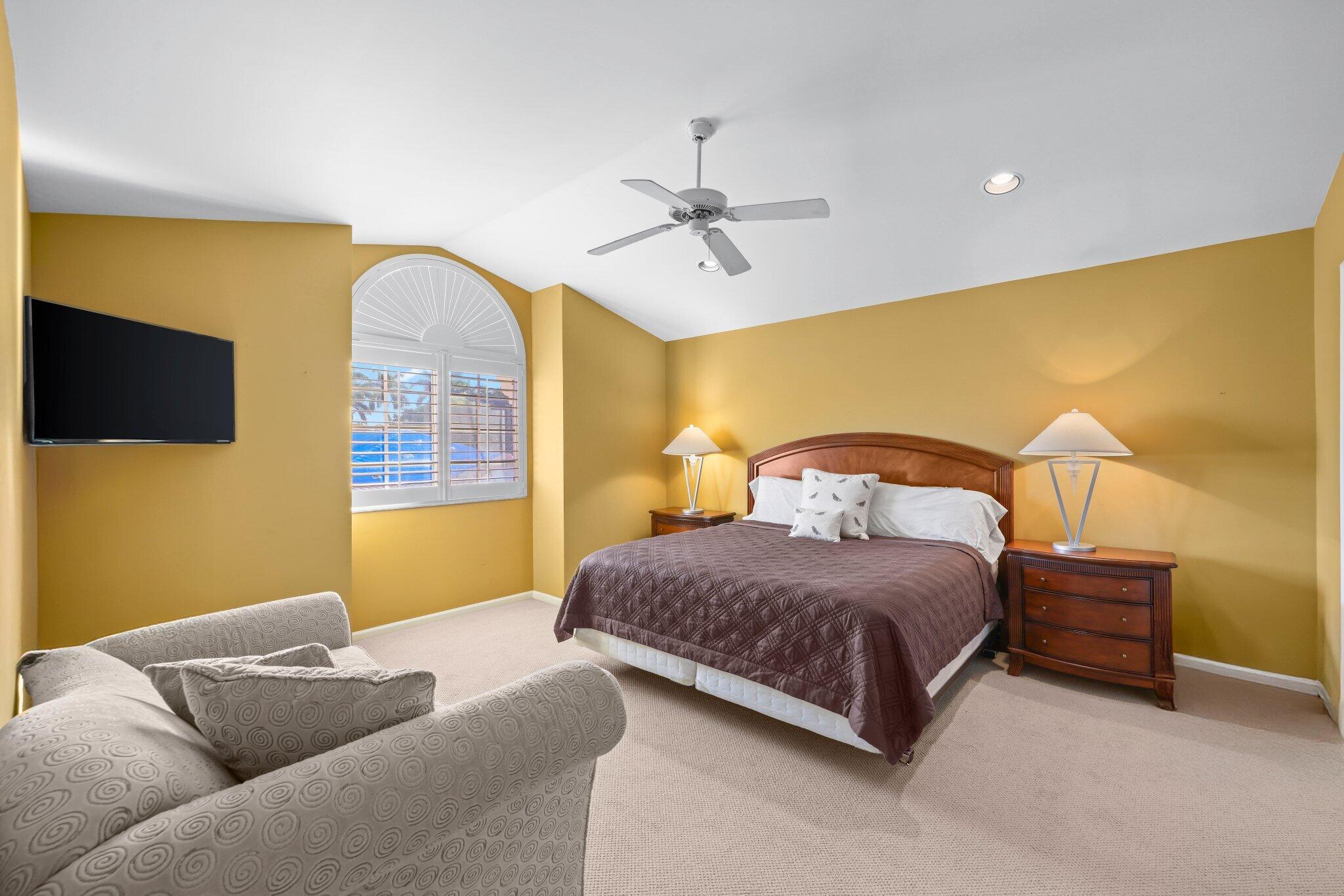 2595 Northwest 53rd Street Boca Raton, FL 33496 - Photo 16 of 48 a bedroom with a bed and a flat screen tv