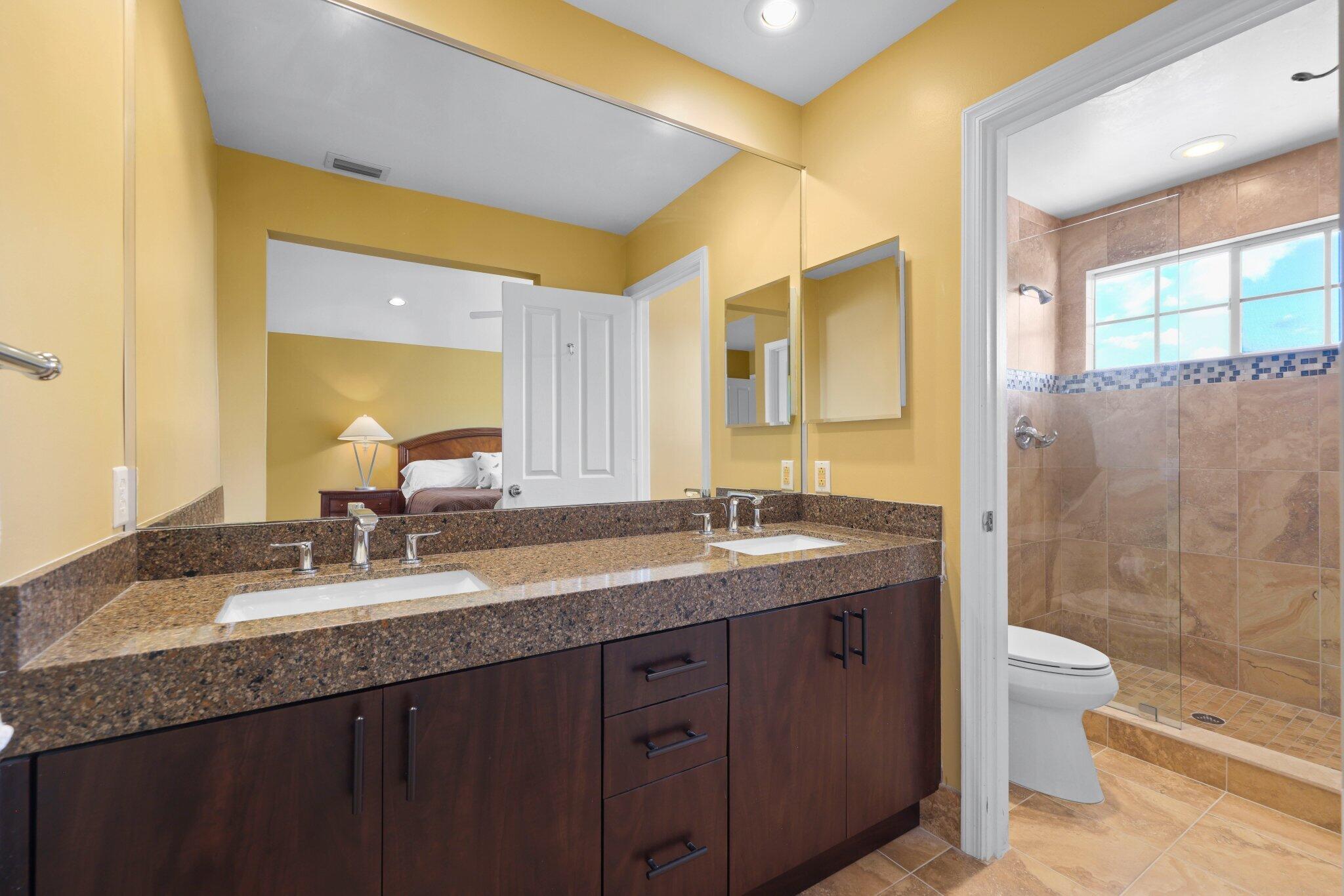 2595 Northwest 53rd Street Boca Raton, FL 33496 - Photo 17 of 48 a bathroom with a granite countertop sink mirror and double