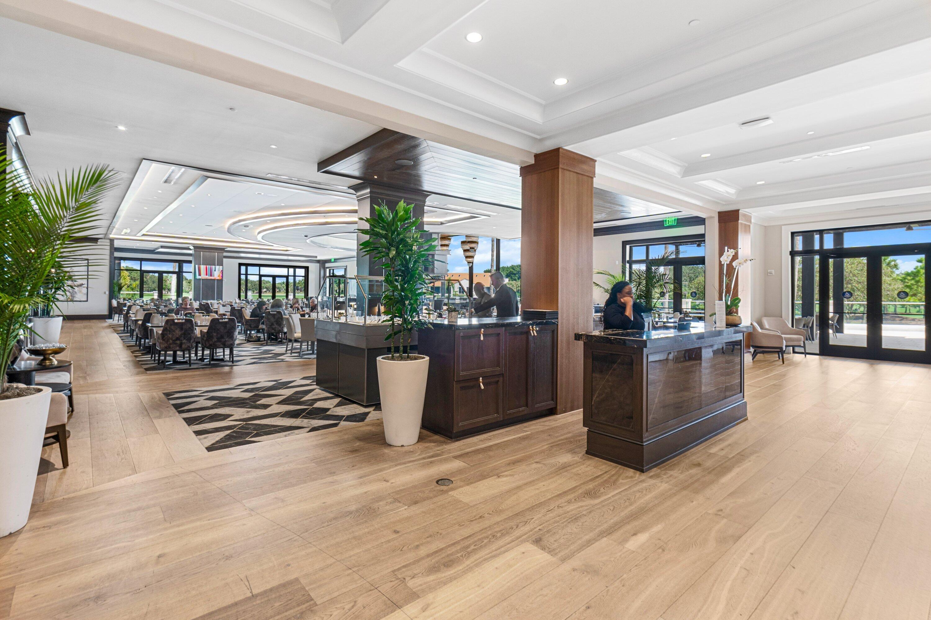 2595 Northwest 53rd Street Boca Raton, FL 33496 - Photo 30 of 48 a view of a living room and kitchen with furniture wooden floor and windows