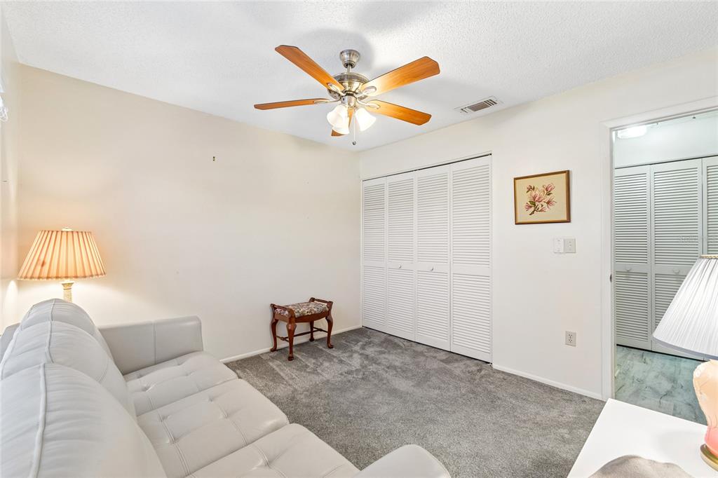 11340 Carriage Hill Drive, Unit 4 Port Richey, FL 34668 - Photo 10 of 36 a work room with furniture and window