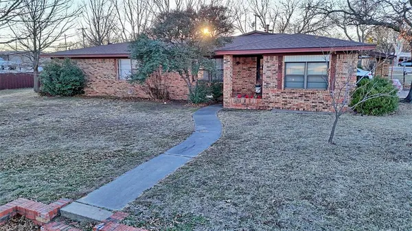 a view of a house with a yard and tree