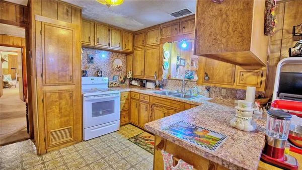a view of a kitchen with furniture and a tub