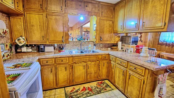 a kitchen that has a sink and a stove in it