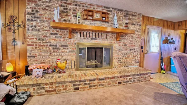 a view of a fireplace with two windows