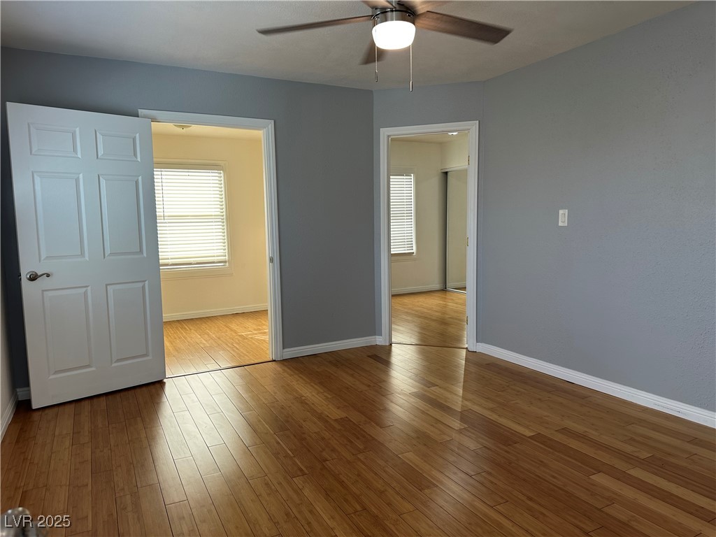 628 B, Unit C Boulder City, NV 89005 - Photo 3 of 12 Spare room featuring a ceiling fan, wood finished floors, and baseboards