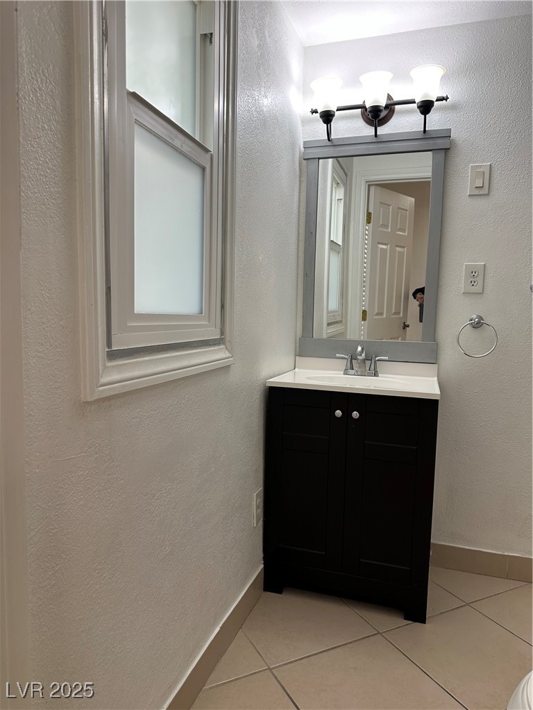 628 B, Unit C Boulder City, NV 89005 - Photo 8 of 12 Bathroom featuring tile patterned floors, vanity, and baseboards