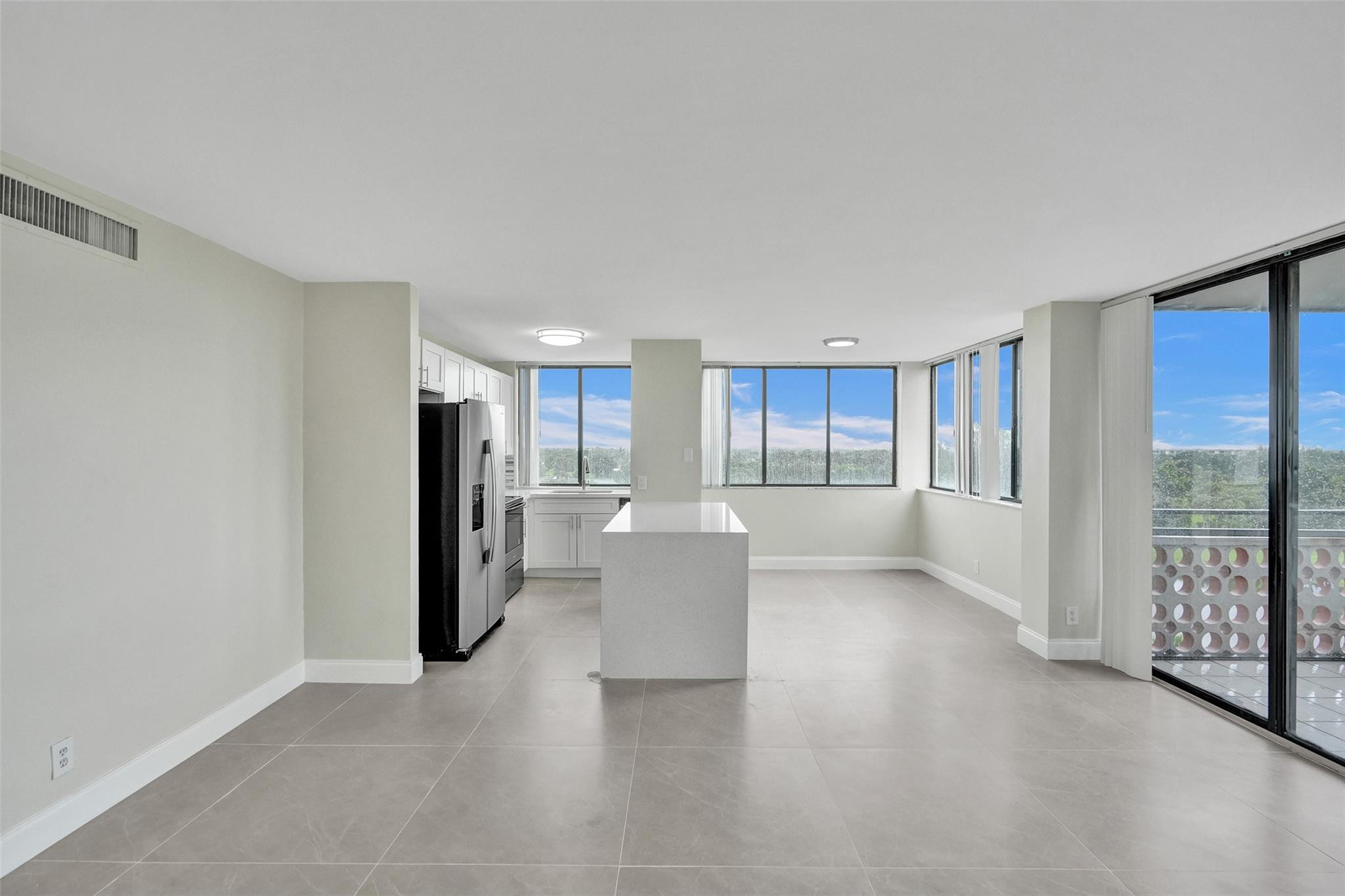 4222 Inverrary Boulevard, Unit 4810 Lauderhill, FL 33319 - Photo 17 of 63 a view of a kitchen and an empty room with a window