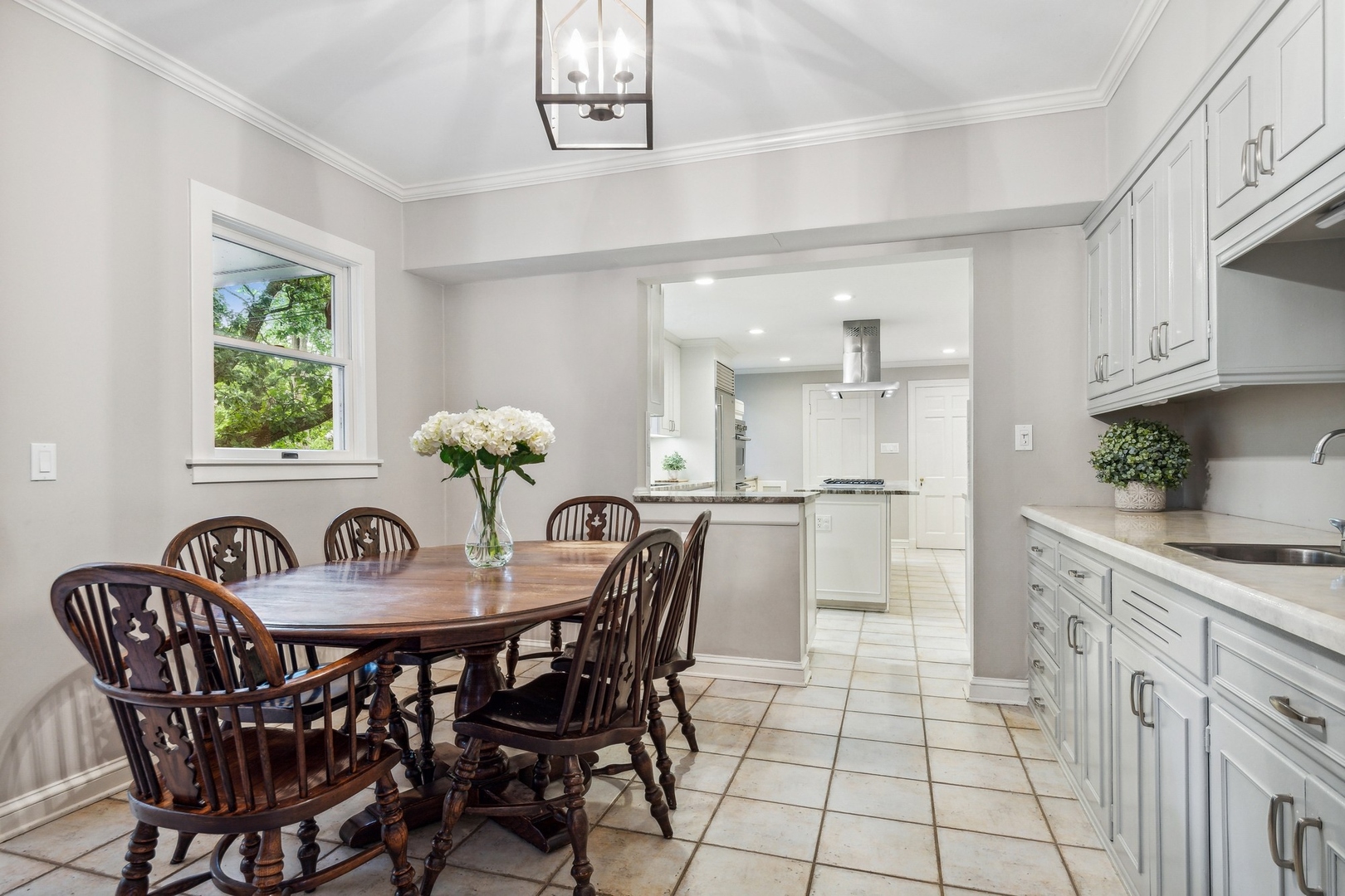 382 Ridge Avenue Winnetka, IL 60093 - Photo 24 of 43 a view of a dining room and kitchen with furniture a kitchen and chandelier