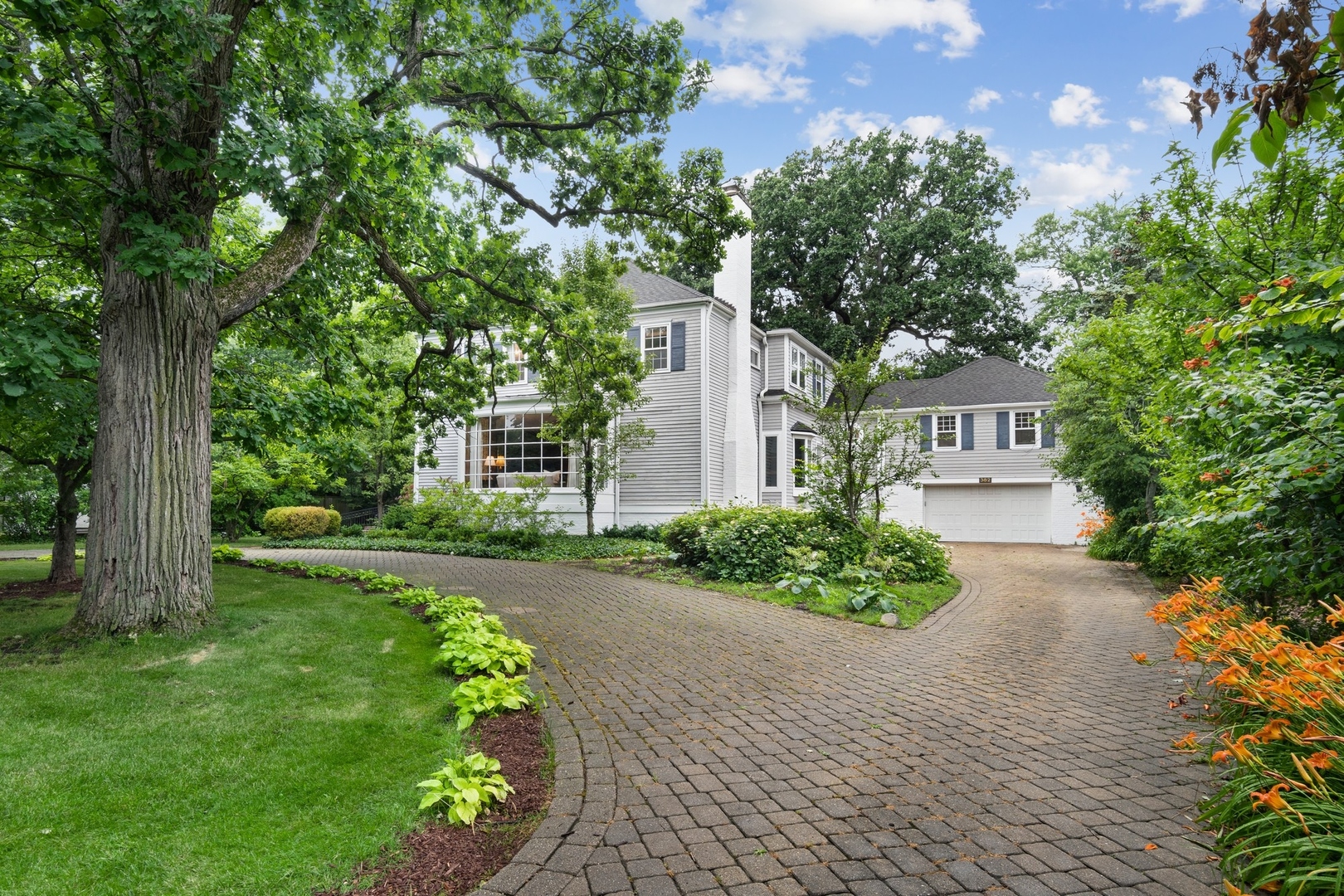382 Ridge Avenue Winnetka, IL 60093 - Photo 4 of 43 a front view of a house with a garden