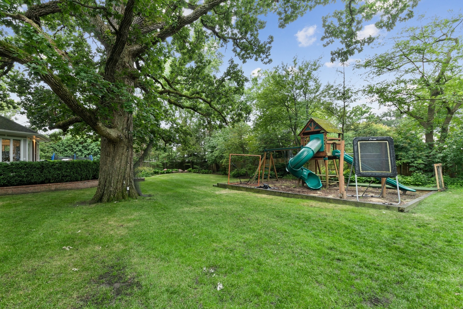 382 Ridge Avenue Winnetka, IL 60093 - Photo 42 of 43 a view of a park with slide trees and wooden fence