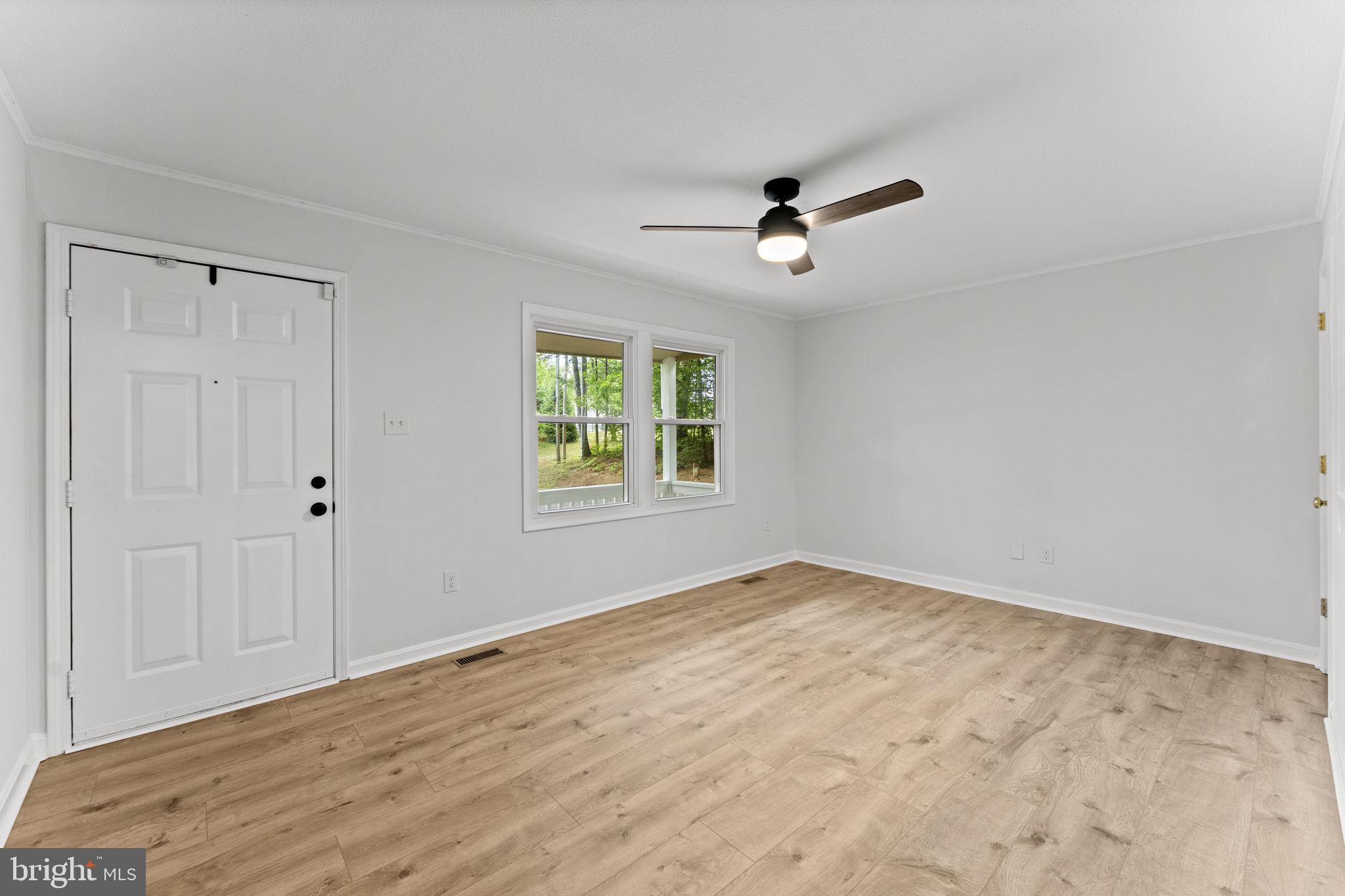1821 James City Road Reva, VA 22735 - Photo 11 of 44 a view of empty room with wooden floor and fan