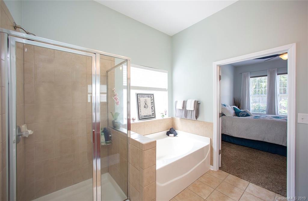 228 Sand Paver Way, Unit 64 Fort Mill, SC 29708 - Photo 22 of 40 a en suite bathroom with a tub shower and sink