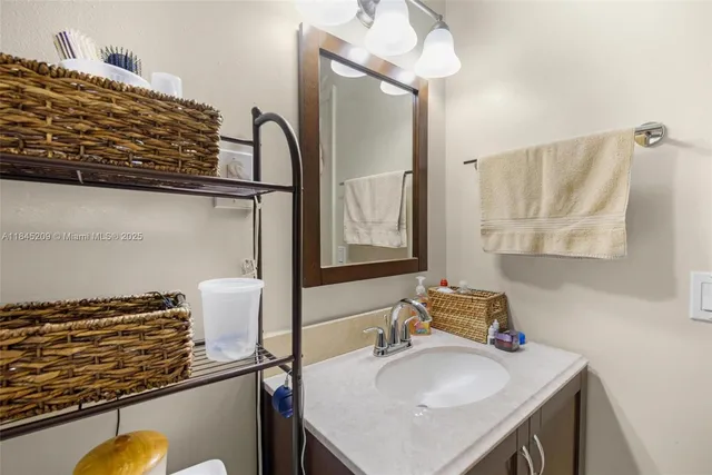 a bathroom with a sink vanity and a mirror