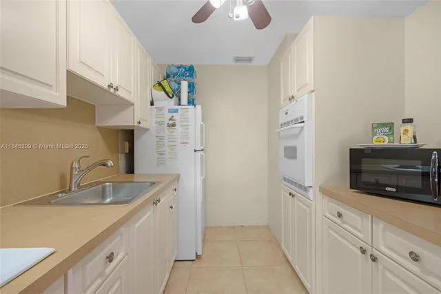 a kitchen with stainless steel appliances a sink and a refrigerator