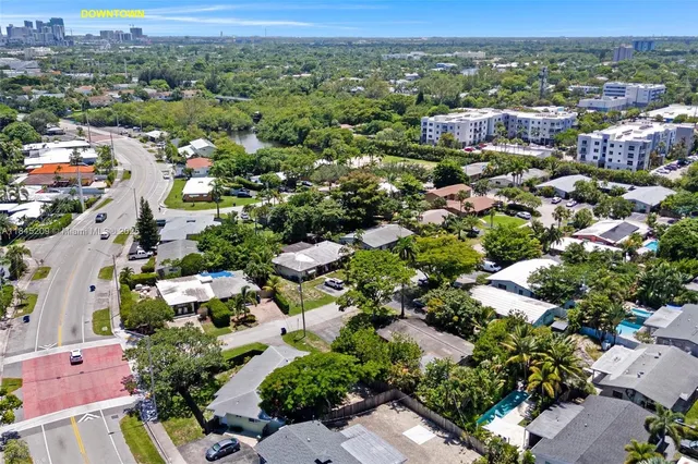 an aerial view of residential houses with outdoor space and ocean view