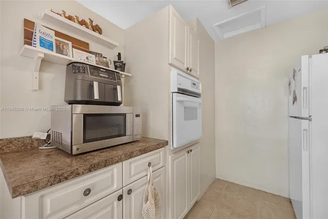 a kitchen with stainless steel appliances granite countertop a stove a microwave and a refrigerator