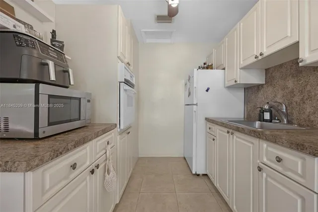 a kitchen with stainless steel appliances granite countertop a sink and a stove