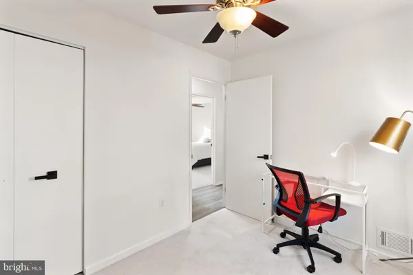 a workspace room with furniture and mirror