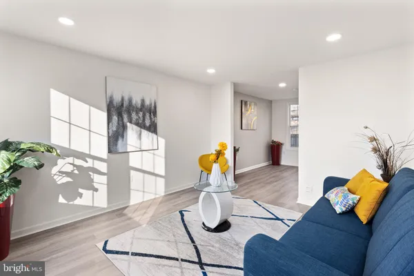 a view of living room with furniture and wooden floor