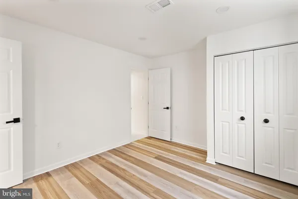 a view of a livingroom with wooden floor and closet