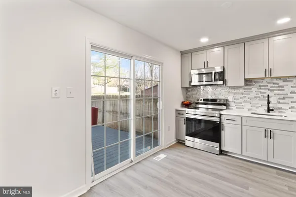 a kitchen with stainless steel appliances a stove top oven and sink