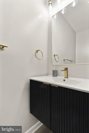 a kitchen with a sink and a mirror