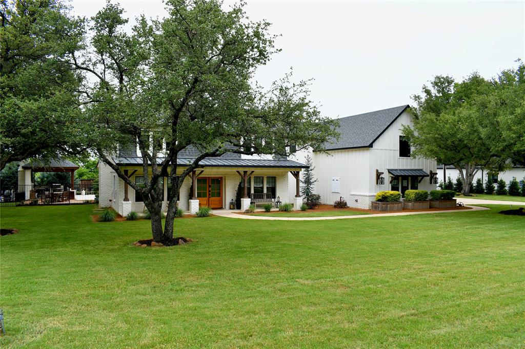 1304 Tinker Road Colleyville, TX 76034 - Photo 2 of 28 a front view of a house with a garden