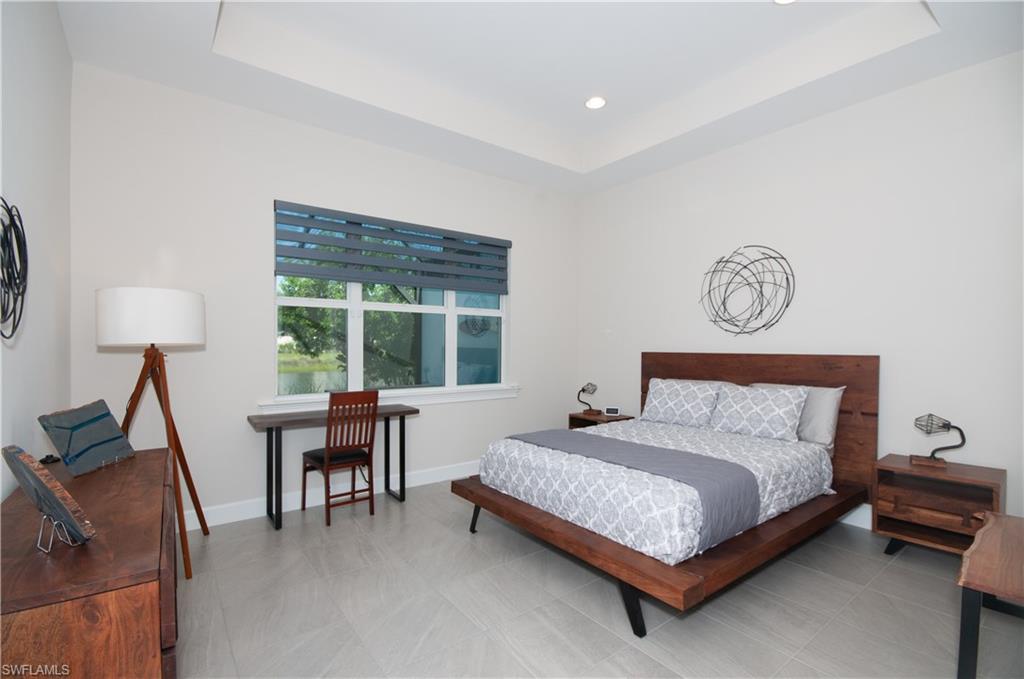5827 Haiti Drive Naples, FL 34113 - Photo 14 of 29 a bedroom with a bed table and a window