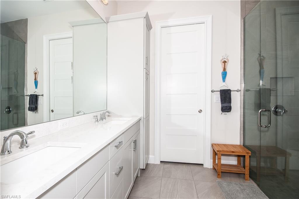 5827 Haiti Drive Naples, FL 34113 - Photo 15 of 29 a bathroom with a sink and a mirror