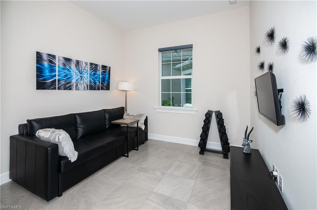 5827 Haiti Drive Naples, FL 34113 - Photo 18 of 29 a living room with furniture and a flat screen tv