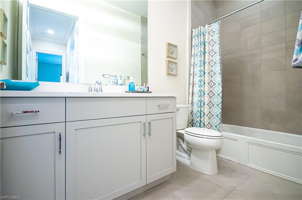 5827 Haiti Drive Naples, FL 34113 - Photo 19 of 29 a bathroom with a toilet sink and mirror
