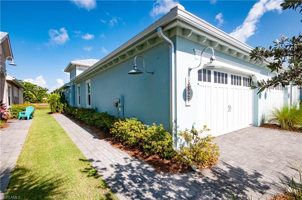 5827 Haiti Drive Naples, FL 34113 - Photo 2 of 29 a front view of a house with garden